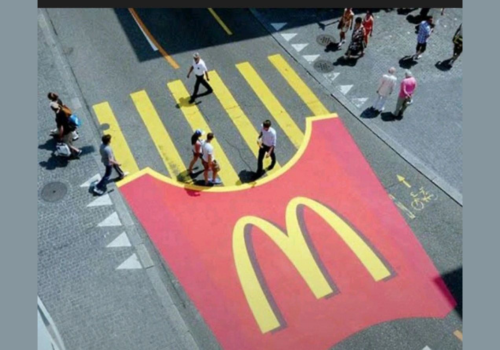 McDonald's pedestrian crossing painted to look like fries spilling from a red fries carton